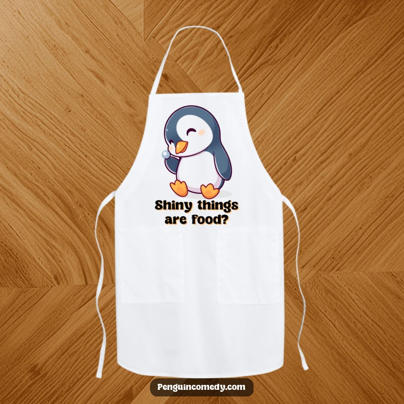 Funny penguin apron, a curious bird tilting its head, eyes wide, captivated by a shiny kitchen utensil, adding humor to cooking.
