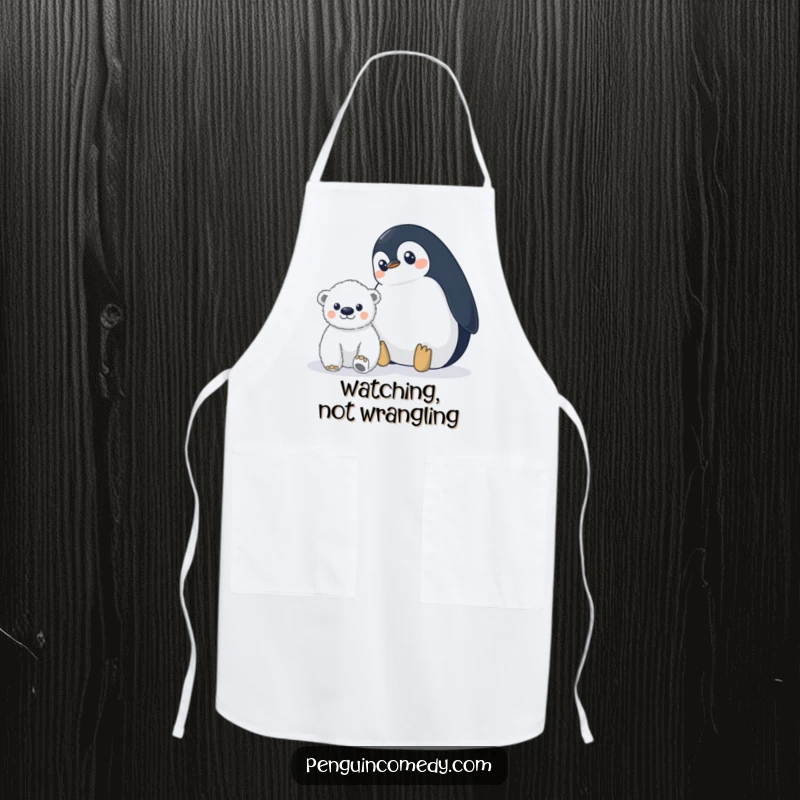 Funny penguin apron showing a wide-eyed penguin watching a distant polar bear cub, adding hilarious vigilance to kitchen tasks.