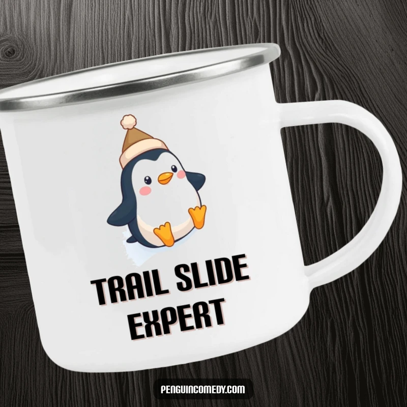 Funny Penguin Hat Camping Mug: A cute penguin with a tiny hat slides down an icy slope, perfect for enjoying drinks by the fire.