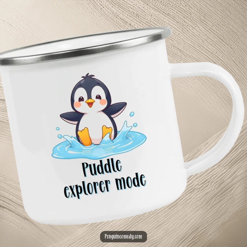 Funny Camping Mug: A playful penguin character splashing in a bright blue puddle, perfect for outdoor fun.
