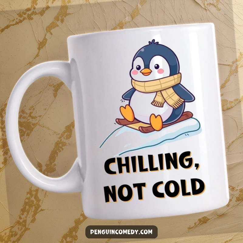 Funny mug with a joyful penguin wearing a scarf, happily sledding down a snowy slope with flippers in the air.