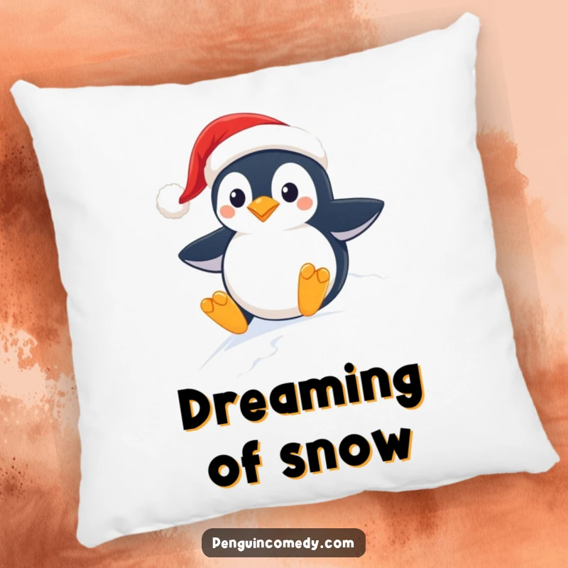 Funny decorative pillow showing a happy penguin wearing a Santa hat, sliding down a snow-covered slope with festive glee.