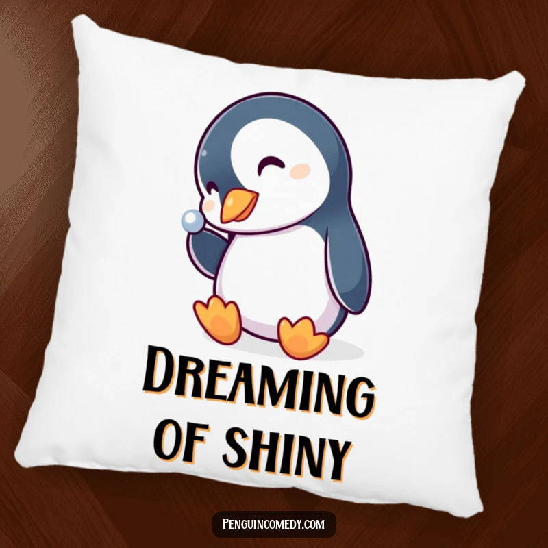 Funny penguin pillow, a cute bird curiously tipping its head to admire a shiny, sparkling object, adding comfort and humor.