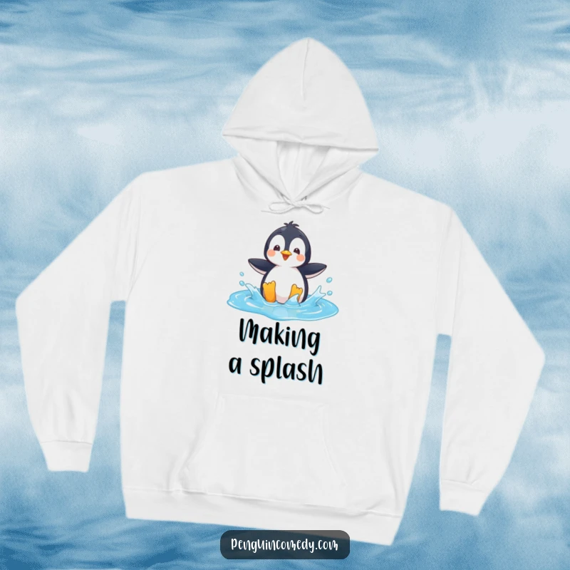 Funny Hoodie: A playful penguin character splashing in a bright blue puddle, embodying carefree joy.