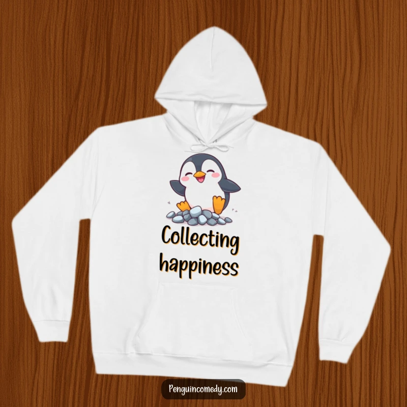 Funny Penguin Rocks Hoodie: A silly penguin chases shiny rocks, offering cozy comfort and playful charm.