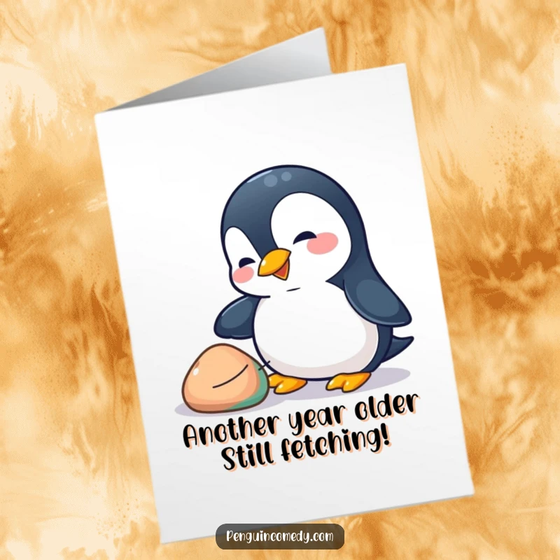 Funny Free Printable Birthday Card: Playful penguin curiously nudging a colorful pebble with its beak.