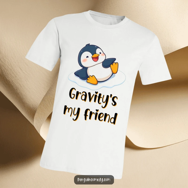 Funny graphic t-shirt featuring a happy penguin giggling while sliding on its belly down an icy surface.