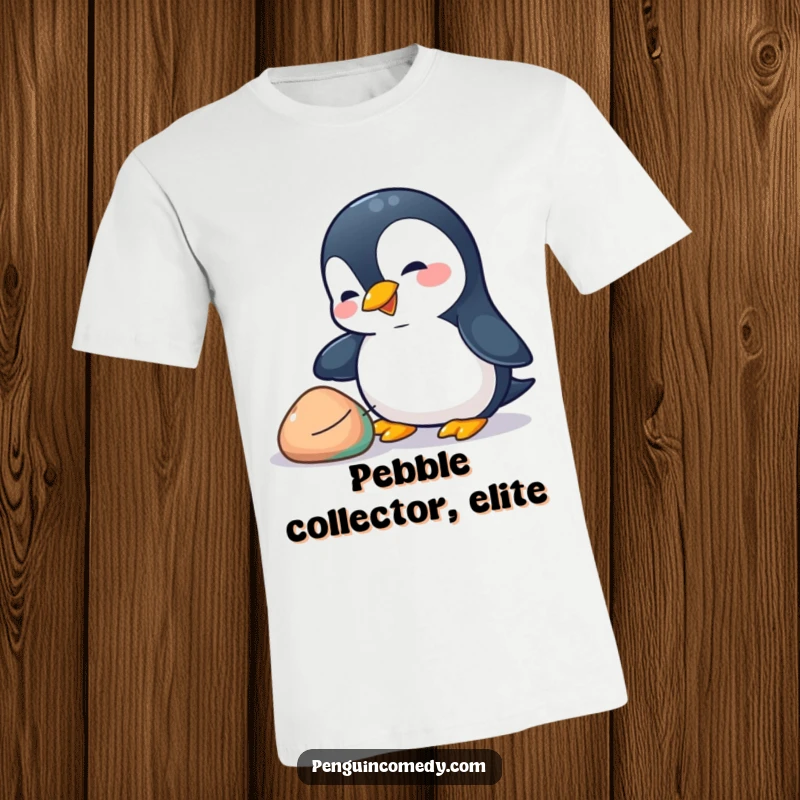 Funny penguin t-shirt depicting a playful penguin enthusiastically nudging a colorful pebble with its beak, celebrating curiosity.