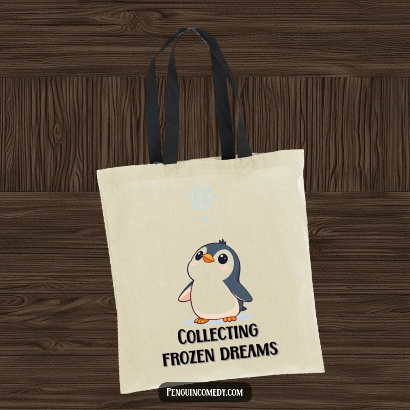 Funny Tote Bag: A curious penguin character looking up at a falling snowflake, embodying winter's gentle magic.